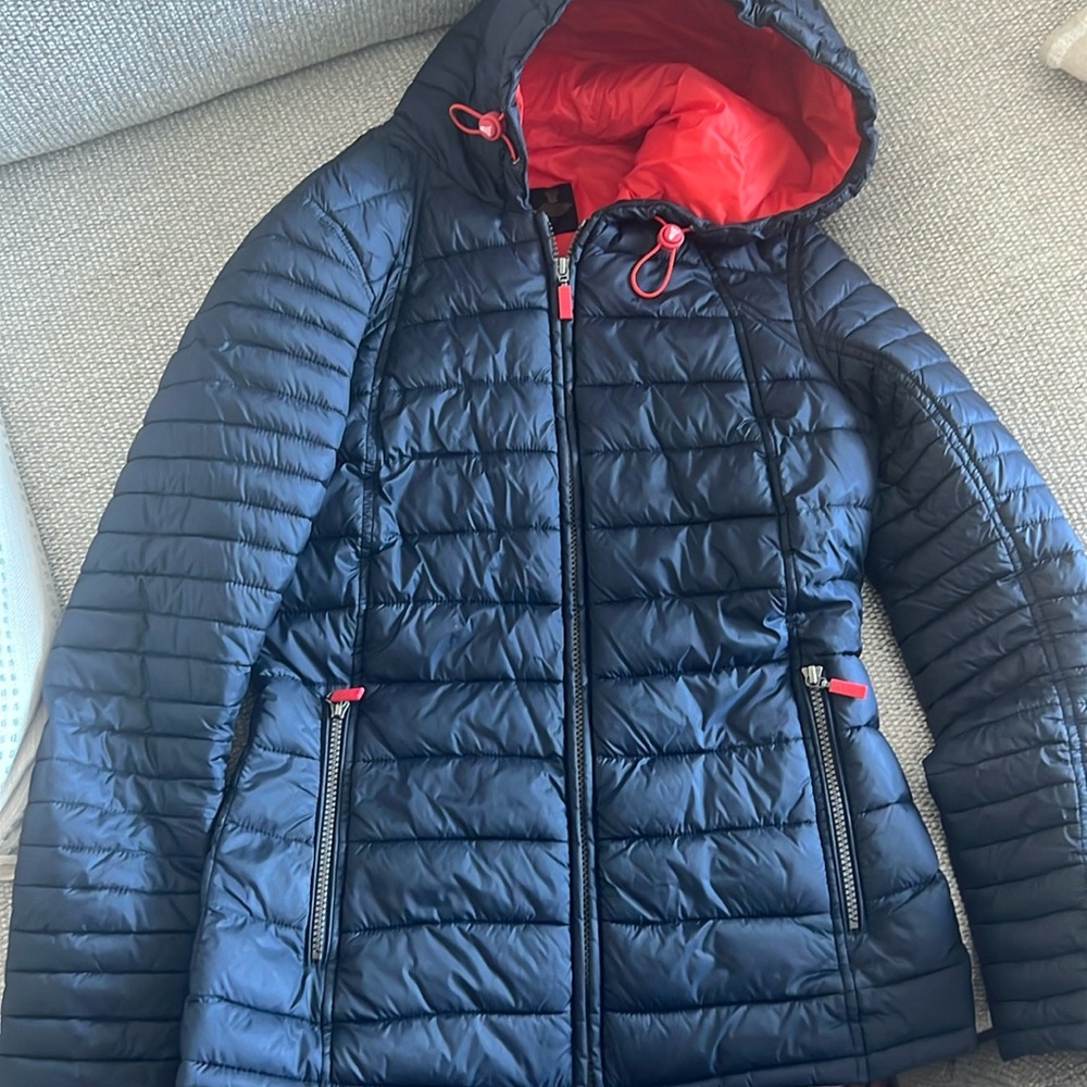 Barbour Women’s Puff Jacket, orange interior and navy exterior.